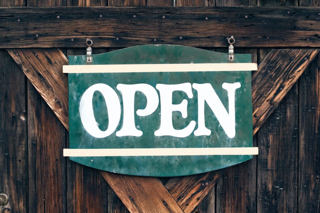 open sign on the wooden doors